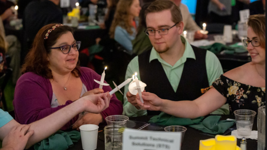STS Sponsored the Dinner in the Dark Event - Lighting vigil candles