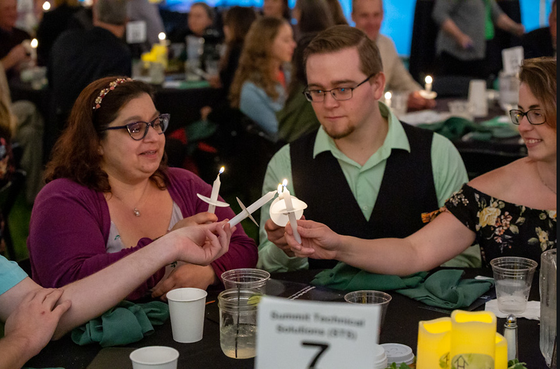 STS Sponsored the Dinner in the Dark Event - Lighting vigil candles